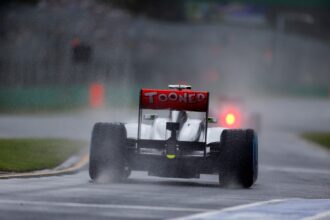 Sergio Perez leaves the pits onto a wet track