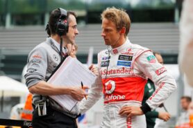 Jenson Button talks with engineer Dave Robson on the grid