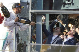 Lewis Hamilton spraying wine at F1 fans on the podium