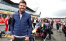 Football player Michael Carrick on the grid next to the car of Max Verstappen