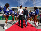 Jenson Button of Great Britain and McLaren Honda and Daniil Kvyat of Russia and Scuderia Toro Rosso walk to the drivers parade before the United States Formula One Grand Prix 2016.