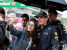 Max Verstappen poses for a photo with a fan before the Formula One Grand Prix of Brazil 2016