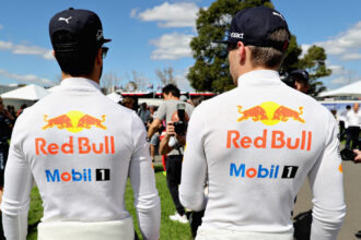 Daniel Ricciardo of Australia and Red Bull Racing and Max Verstappen of Netherlands and Red Bull Racing walk in the Paddock during previews to the Australian Formula One Grand Prix at Albert Park on March 23, 2017 in Melbourne, Australia.