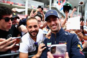 Daniel Ricciardo of Red Bull Racing poses for a selfie with a fan during previews ahead of the Spanish GP F1/2018.