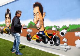 An artist paints a Daniel Ricciardo of Australia and Red Bull Racing mural in the fan area during the Spanish Formula One Grand Prix at Circuit de Catalunya on May 13, 2018 in Montmelo, Spain.