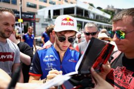 Pierre Gasly of Scuderia Toro Rosso signs autographs for fans in the Paddock during previews ahead of the Monaco GP 2018.