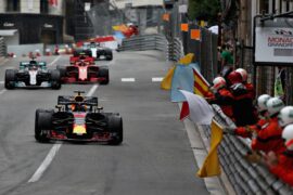 Race winner Daniel Ricciardo of Red Bull Racing RB14 TAG Heuer is greeted by flag waving marshals during the Monaco Formula One Grand Prix at Circuit de Monaco on May 27, 2018 in Monte-Carlo, Monaco.