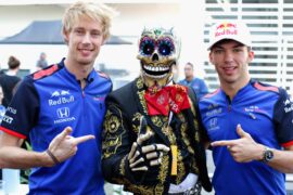 Pierre Gasly of France and Scuderia Toro Rosso and Brendon Hartley of New Zealand and Scuderia Toro Rosso meet a Day of the Dead performer in the Paddock during previews ahead of the Formula One Grand Prix of Mexico at Autodromo Hermanos Rodriguez on October 25, 2018 in Mexico City, Mexico.
