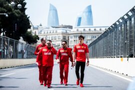 Charles Leclerc does a track inspection with his Ferrari crew